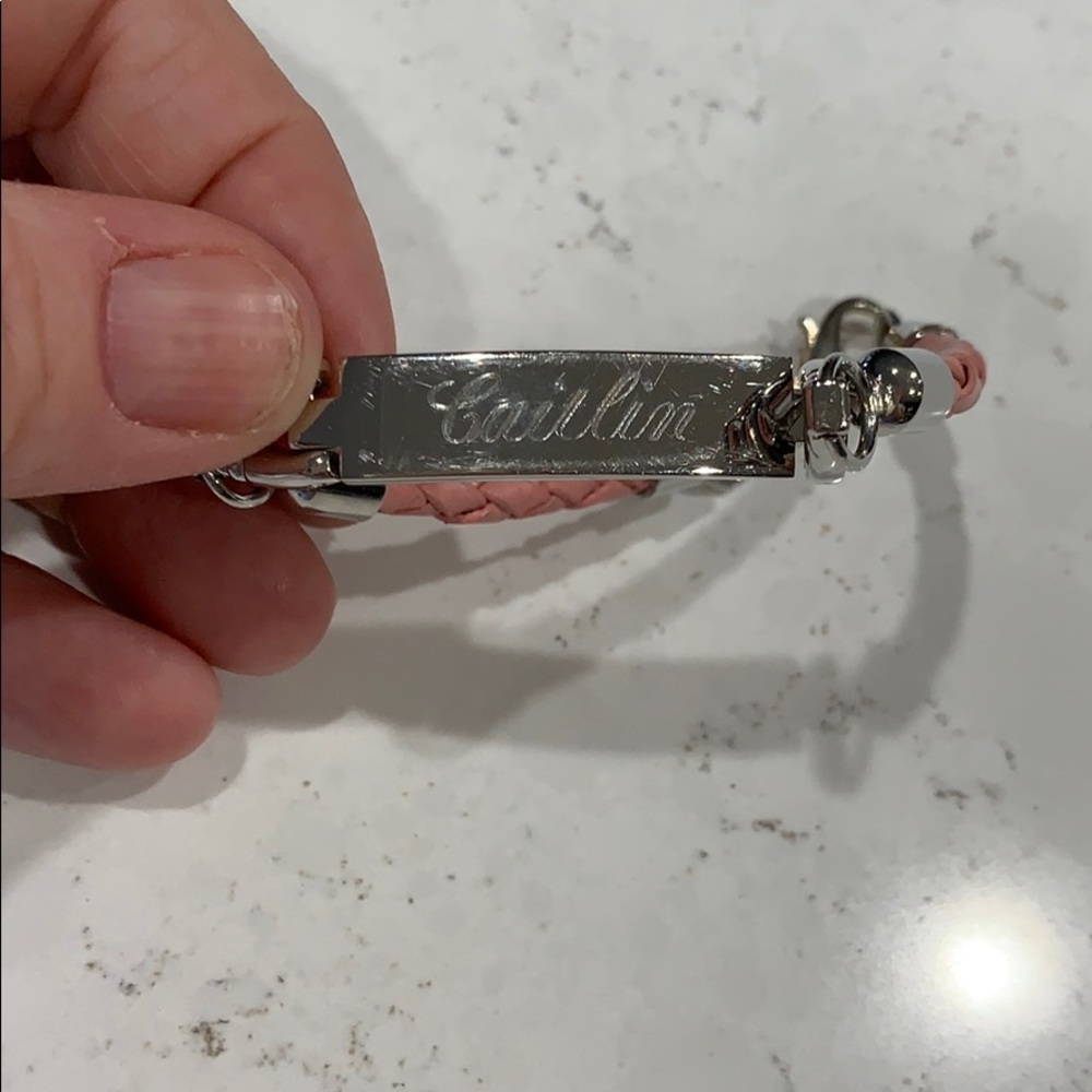 Pink Braided ID bracelet inscribed “Caitlin”